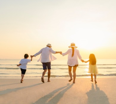 Family holding hands on the beach | Williamson Realty Vacations Ocean Isle Beach Rentals