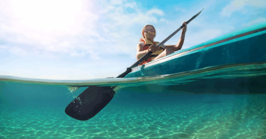 woman kayaking in clear water