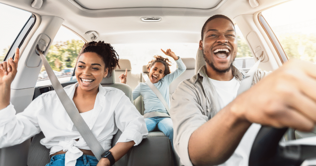 happy family in car on road trip