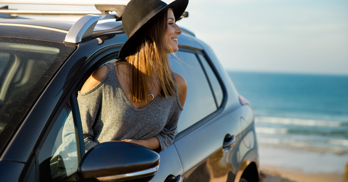 woman in car by ocean