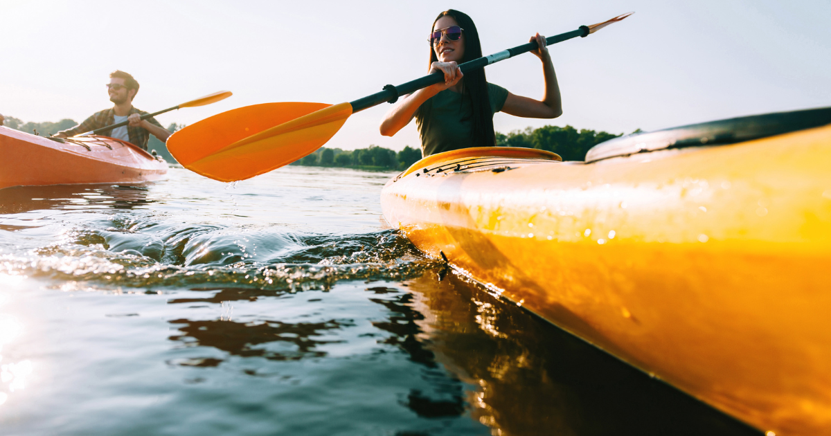 man and woman kayaking in yellow kayaks