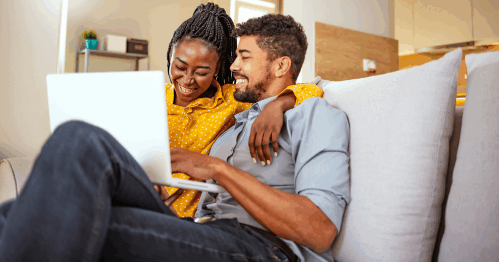 couple on couch looking at computer
