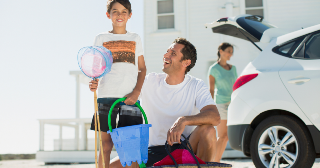 family unloading car for beach day