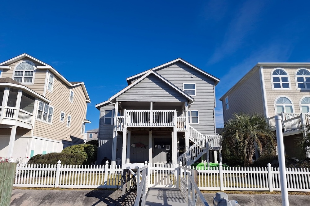 Exterior of a canal-view home in Ocean Isle Beach available to rent for Oyster Fest weekend from Williamson Realty.