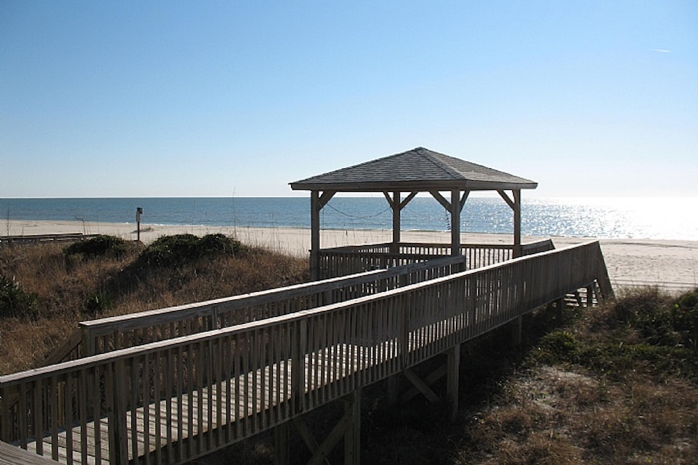 View of a covered gazebo on a private beach access boardwalk at an ocean isle beach vacation rental.