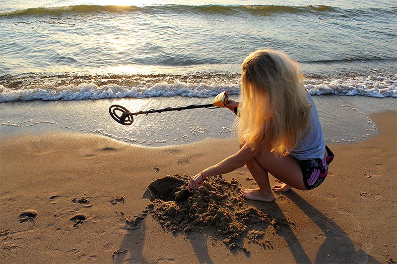 Woman Metal Detecting | Williamson Realty Vacations Ocean Isle Beach Rentals