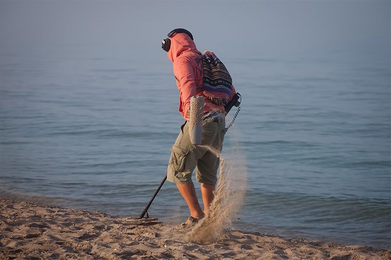 Man Metal Detecting | Williamson Realty Vacations Ocean Isle Beach Rentals