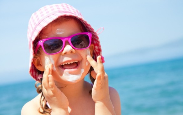 little girl wearing sunglasses on the beach | Williamson Realty