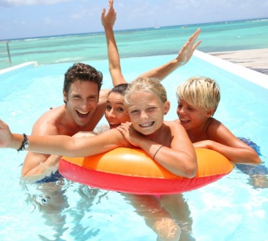 family enjoying oceanfront swimming pool | Williamson Realty