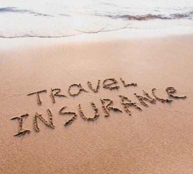 travel insurance written in the sand on the beach | Williamson Realty