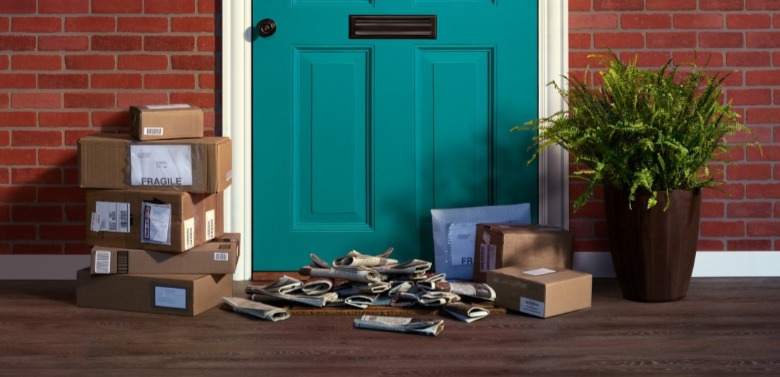 packages and newspaper piled up outside door | Williamson Realty