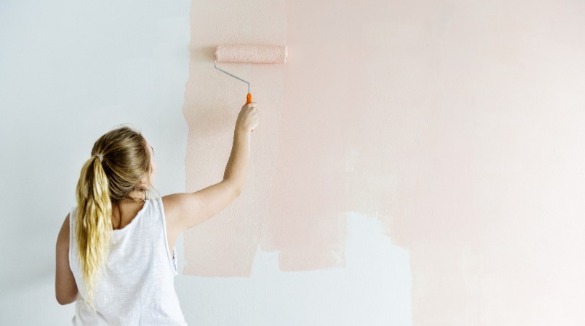 woman painting wall light pink | Williamson Realty
