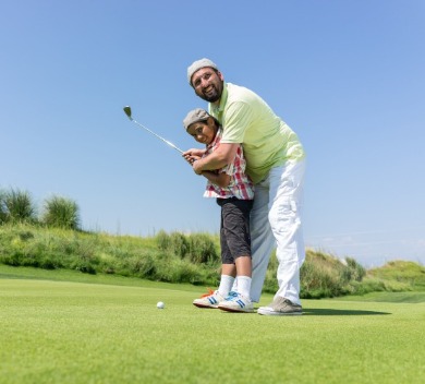 Father and son on golf course | Williamson Realty Vacations Ocean Isle Beach NC Rentals