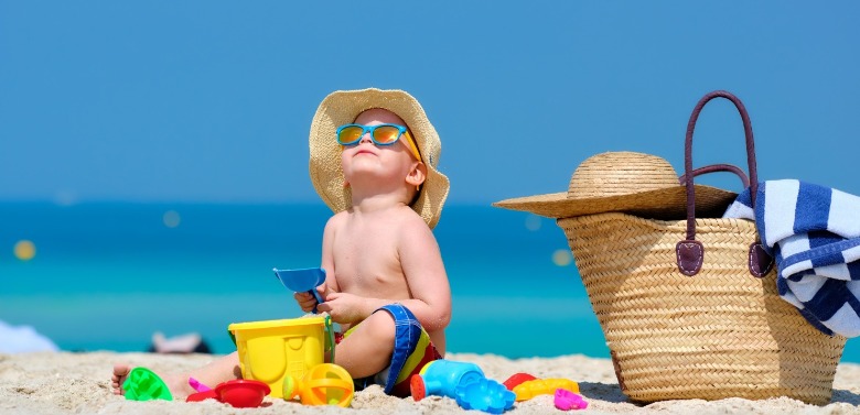 little boy playing on the beach with toys | Williamson Realty