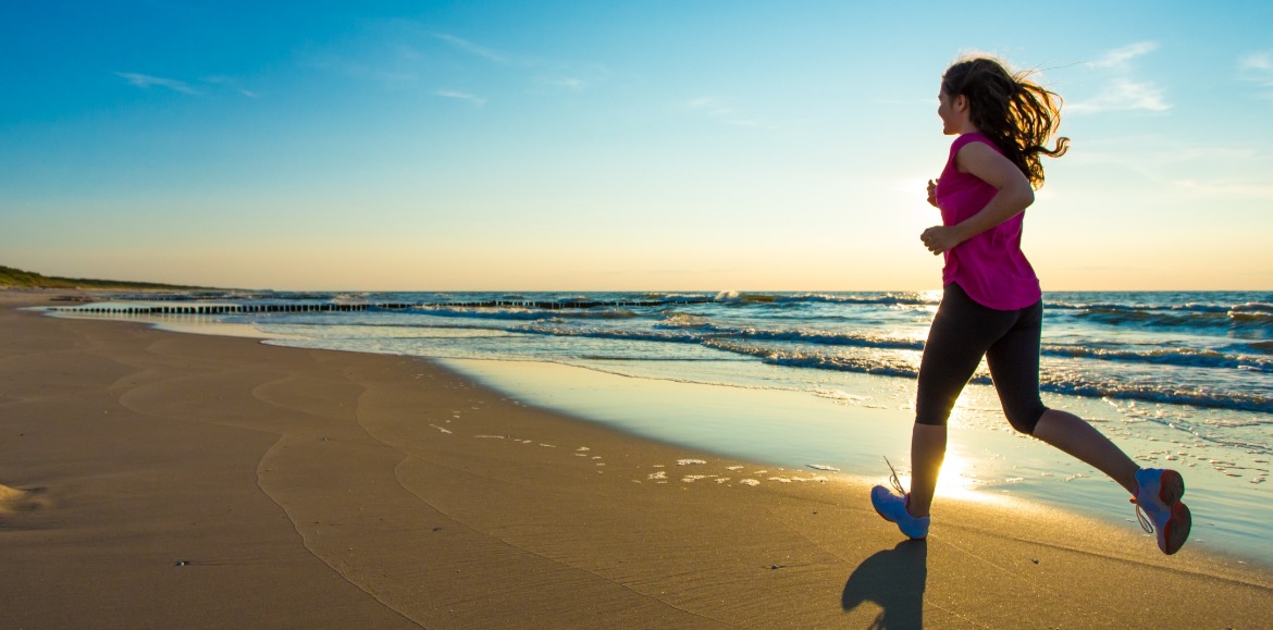 woman running on the beach | Williamson Realty