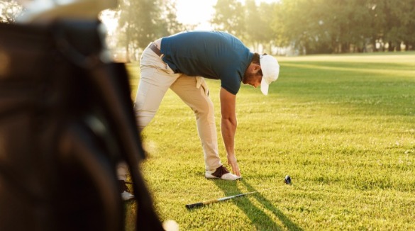 man stretching before playing golf | Williamson Realty