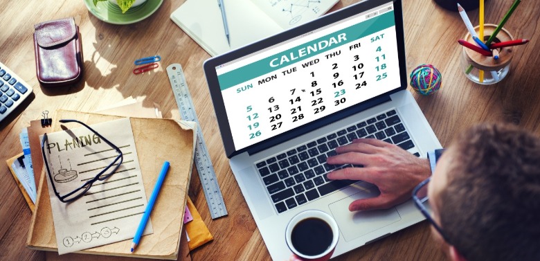 man looking at calendar on computer | Williamson Realty