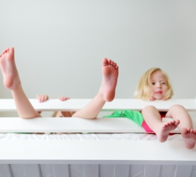 Two young kids playing on top bunk of bunk bed | Williamson Realty Vacations Kid Friendly Ocean Isle Beach Rentals