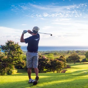 Man swinging golf club near the ocean | Williamson Realty Ocean Isle Beach NC Rentals