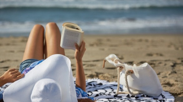  Mom reading a book on the beach | Williamson Realty Ocean Isle Beach NC Vacation Rentals