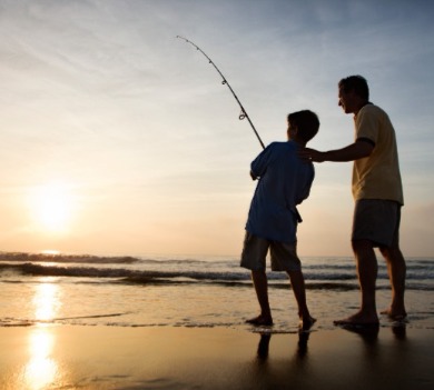 Father and son surf fishing on the beach | Williamson Realty Vacations Ocean Isle Beach Vacation Rentals