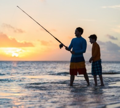 Father and son surf fishing from the beach | Williamson Realty Vacations Ocean Isle Beach NC Vacation Rentals